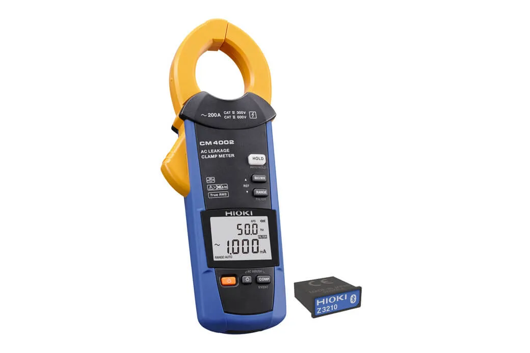 Hioki CM4002 leakage clamp meter clamped around three-phase cable bundle in switchboard